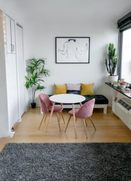 white and pink round table beside white wall