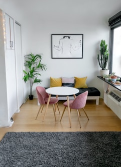 white and pink round table beside white wall