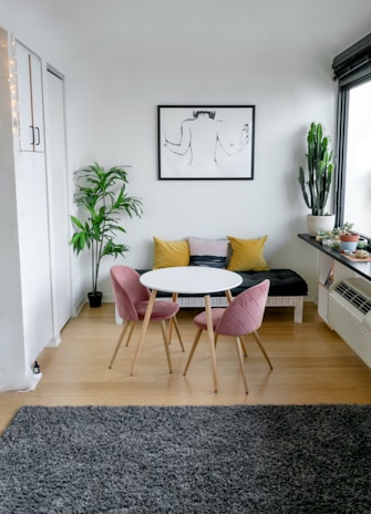 white and pink round table beside white wall