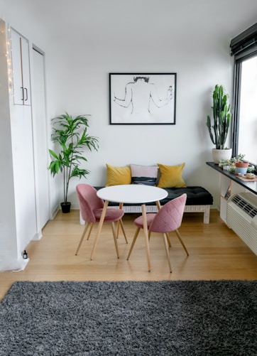 white and pink round table beside white wall