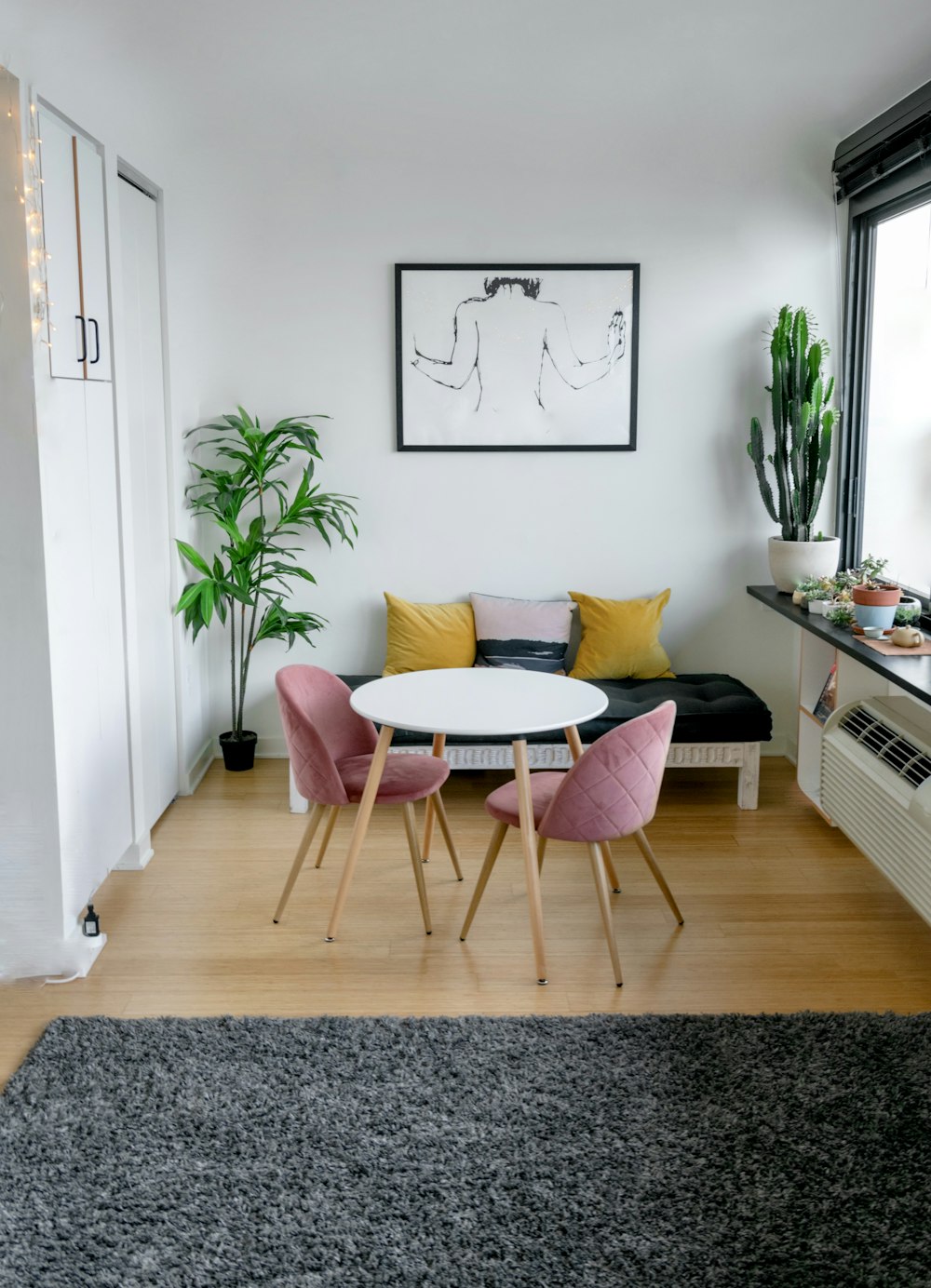 white and pink round table beside white wall