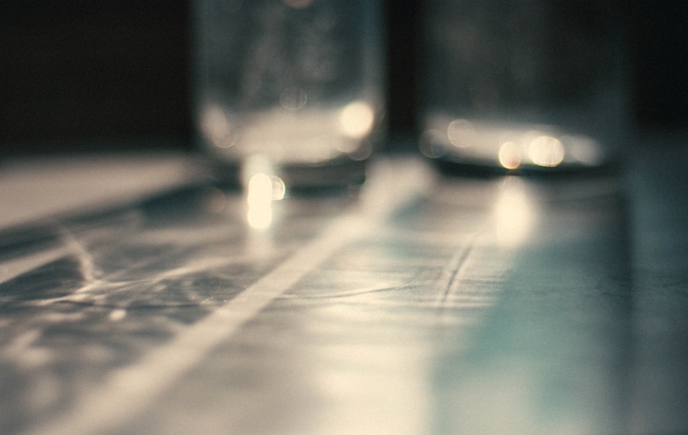 clear drinking glass on brown wooden table