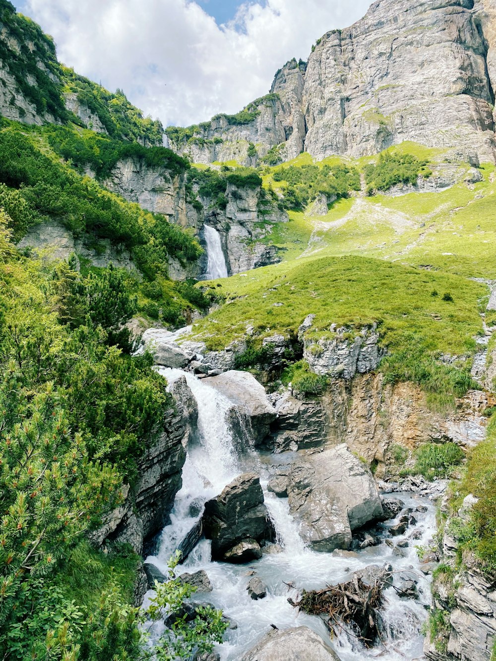 green grass covered mountain with waterfalls