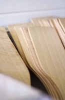 Overhead view of several chopping boards stacked, showing different wood tones.