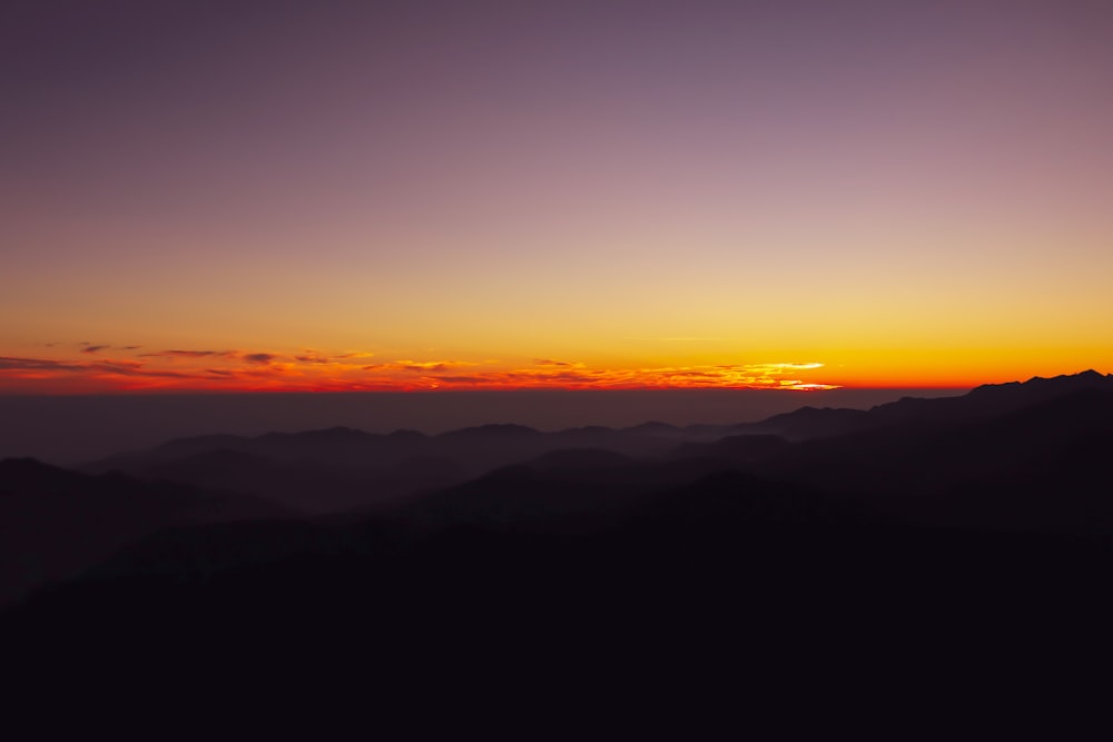 silhouette of mountains during sunset