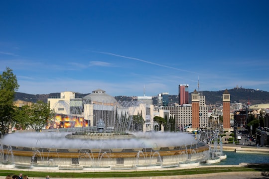 city buildings under blue sky during daytime in The Magic Fountain Spain