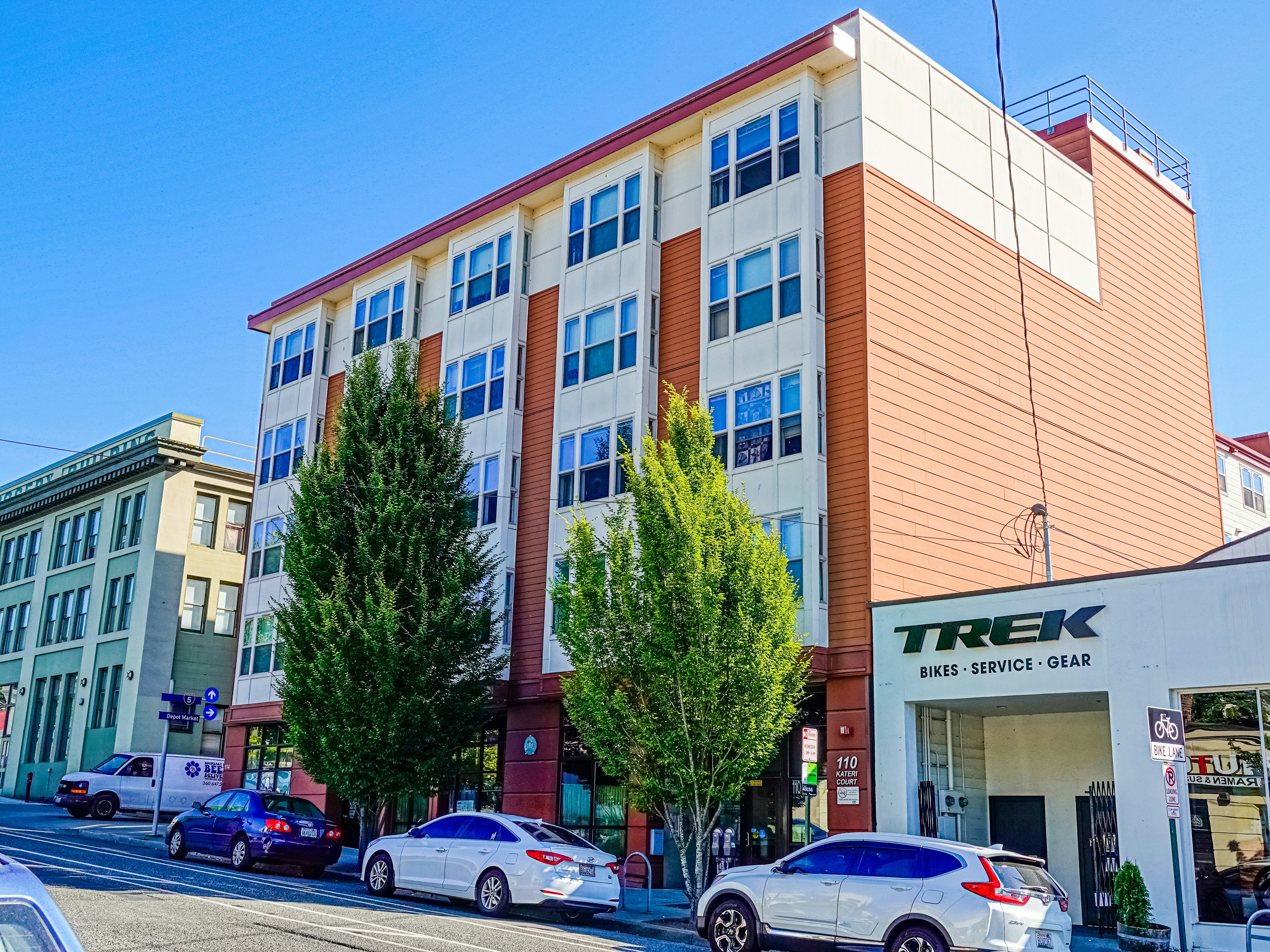cars parked in front of brown building during daytime