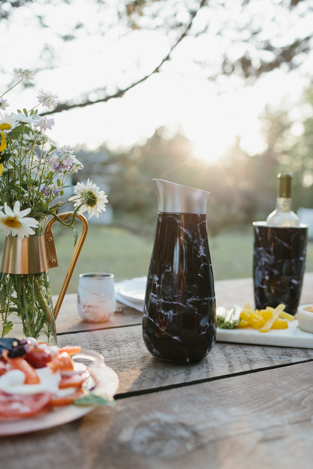 clear glass pitcher with black liquid inside