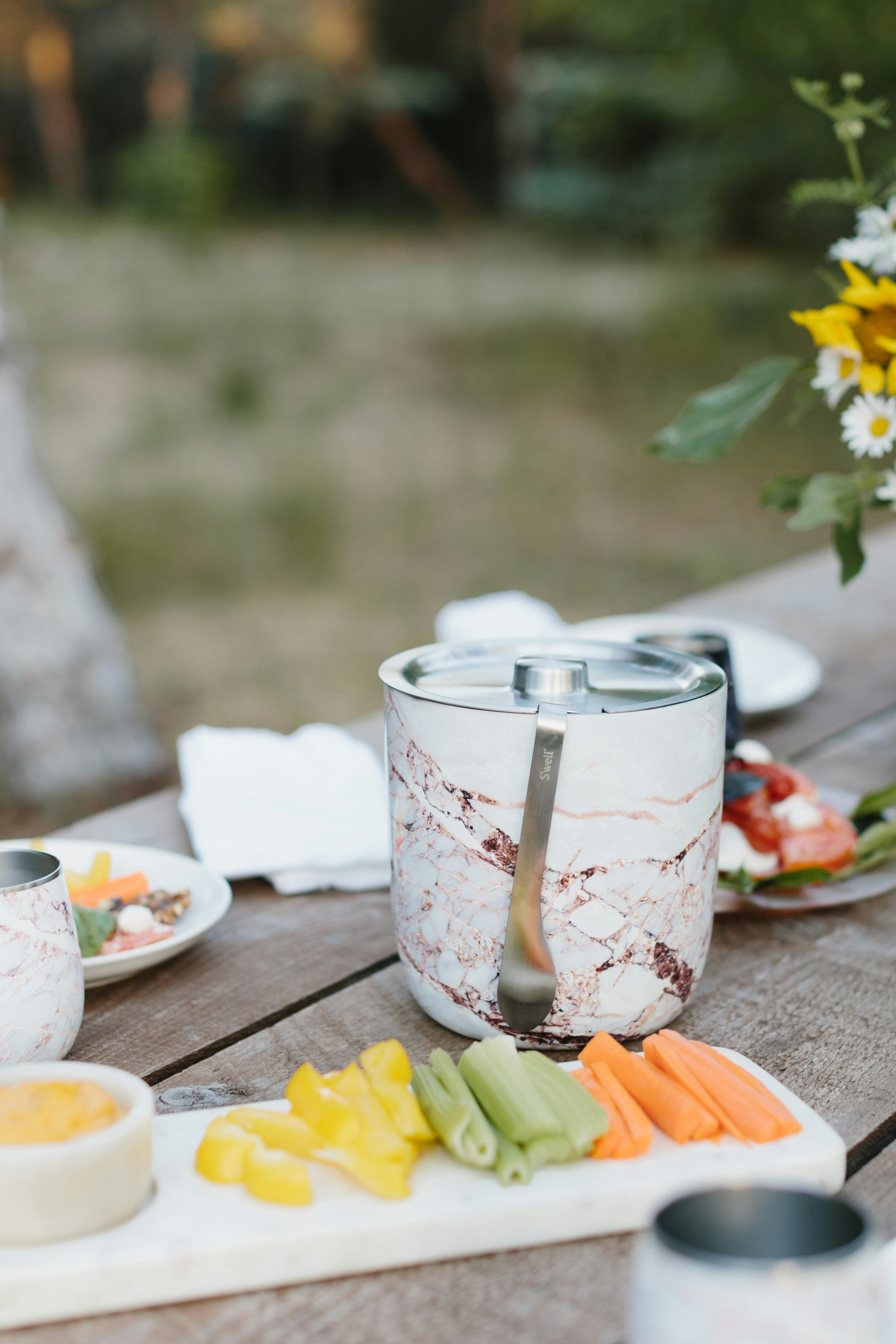 white and red floral ceramic mug on brown wooden table