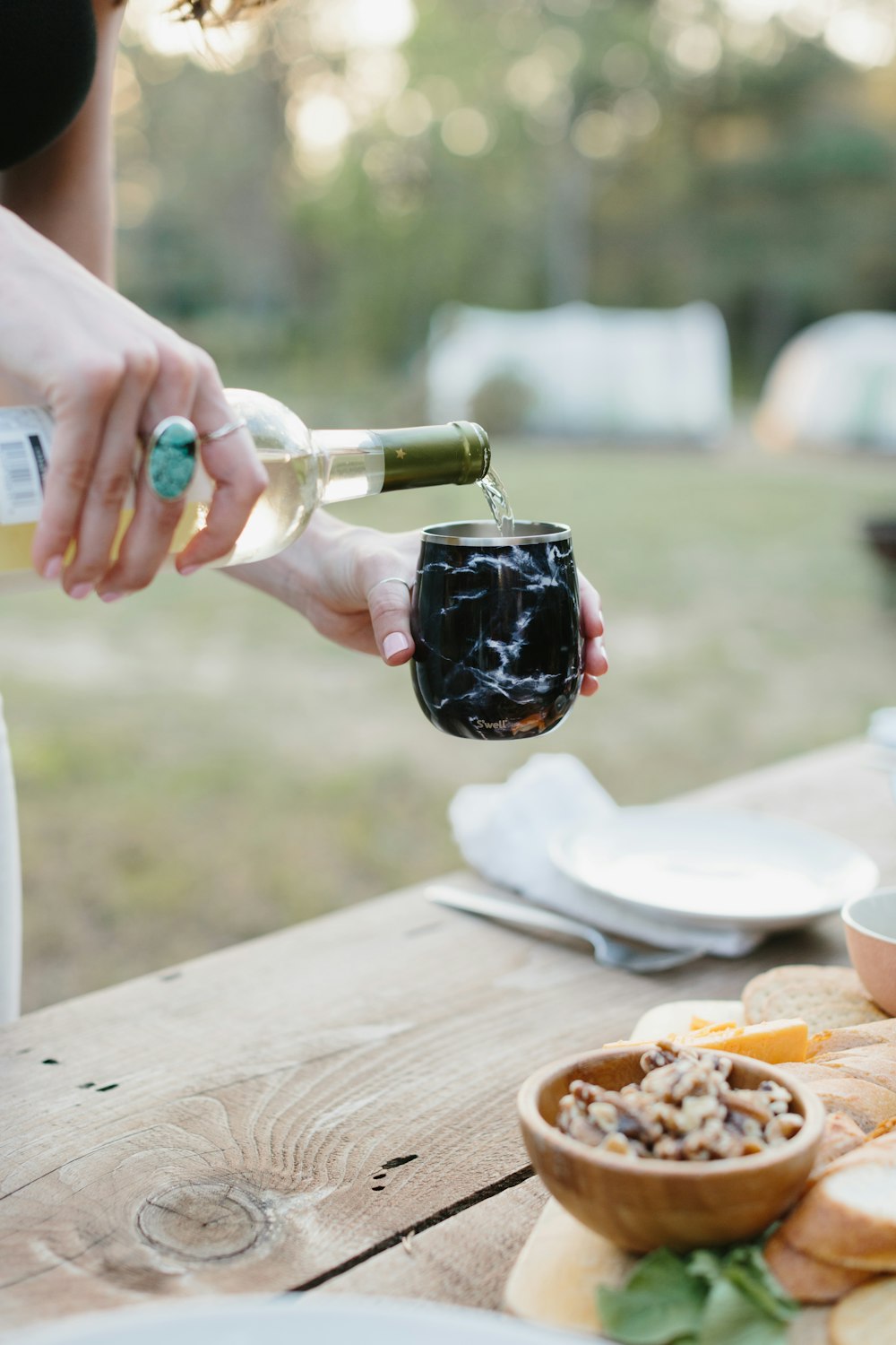 person pouring wine on wine glass