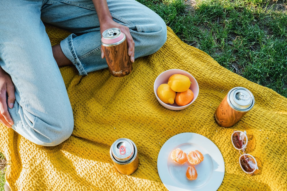 sliced orange fruit on white ceramic plate beside brown ceramic mug on brown wooden table