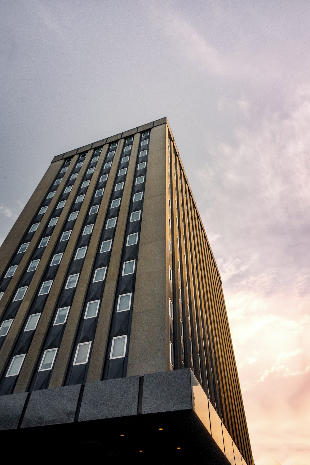 brown concrete building under gray sky