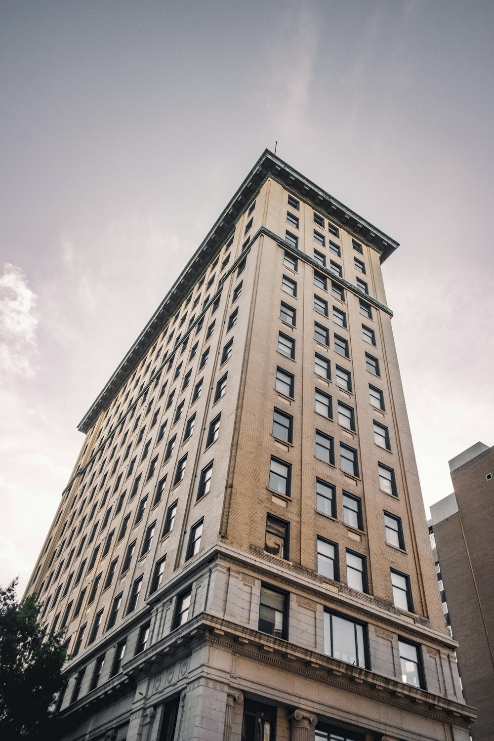 brown concrete building under white clouds during daytime