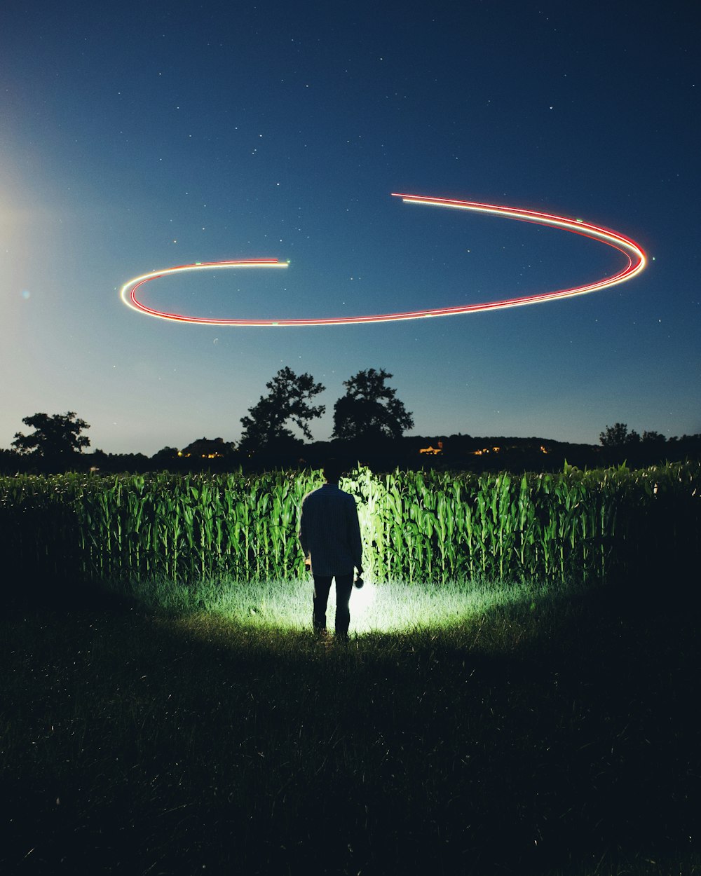 man and woman walking on green grass field during night time