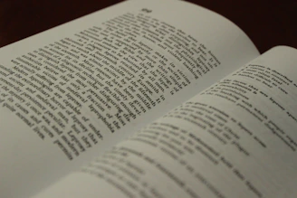 A close-up of an open book showing pages filled with stories and portraits of angel investors.