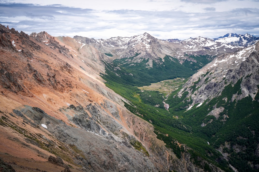 green and brown mountains under white clouds during daytime