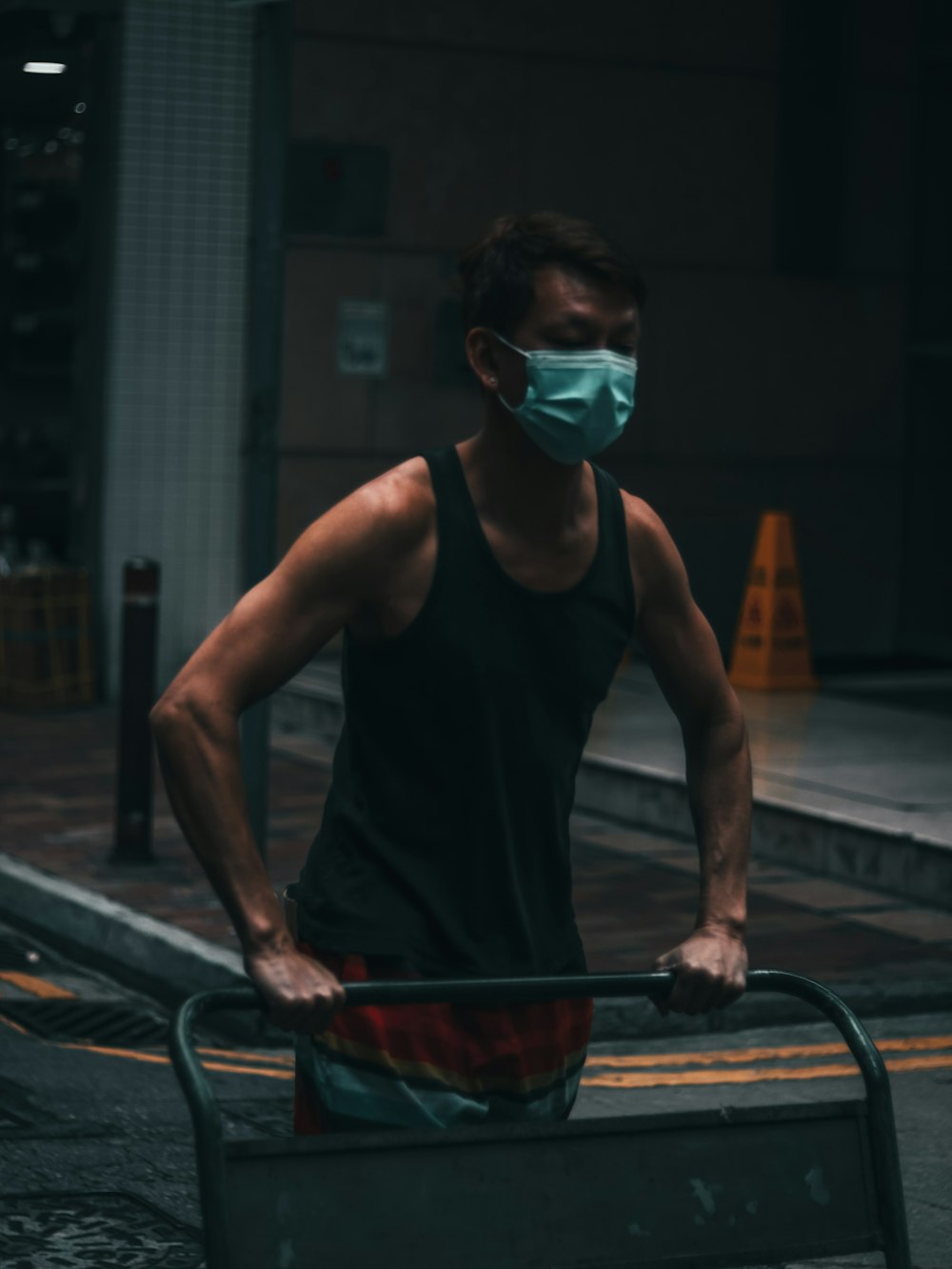 man in black tank top wearing green goggles