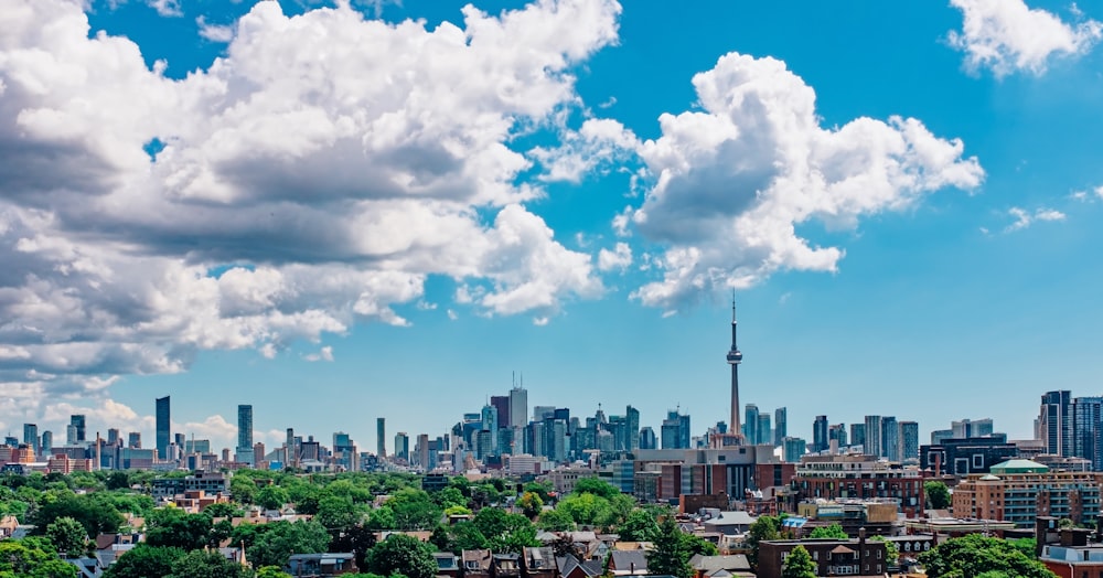 city buildings under blue and white sunny cloudy sky during daytime