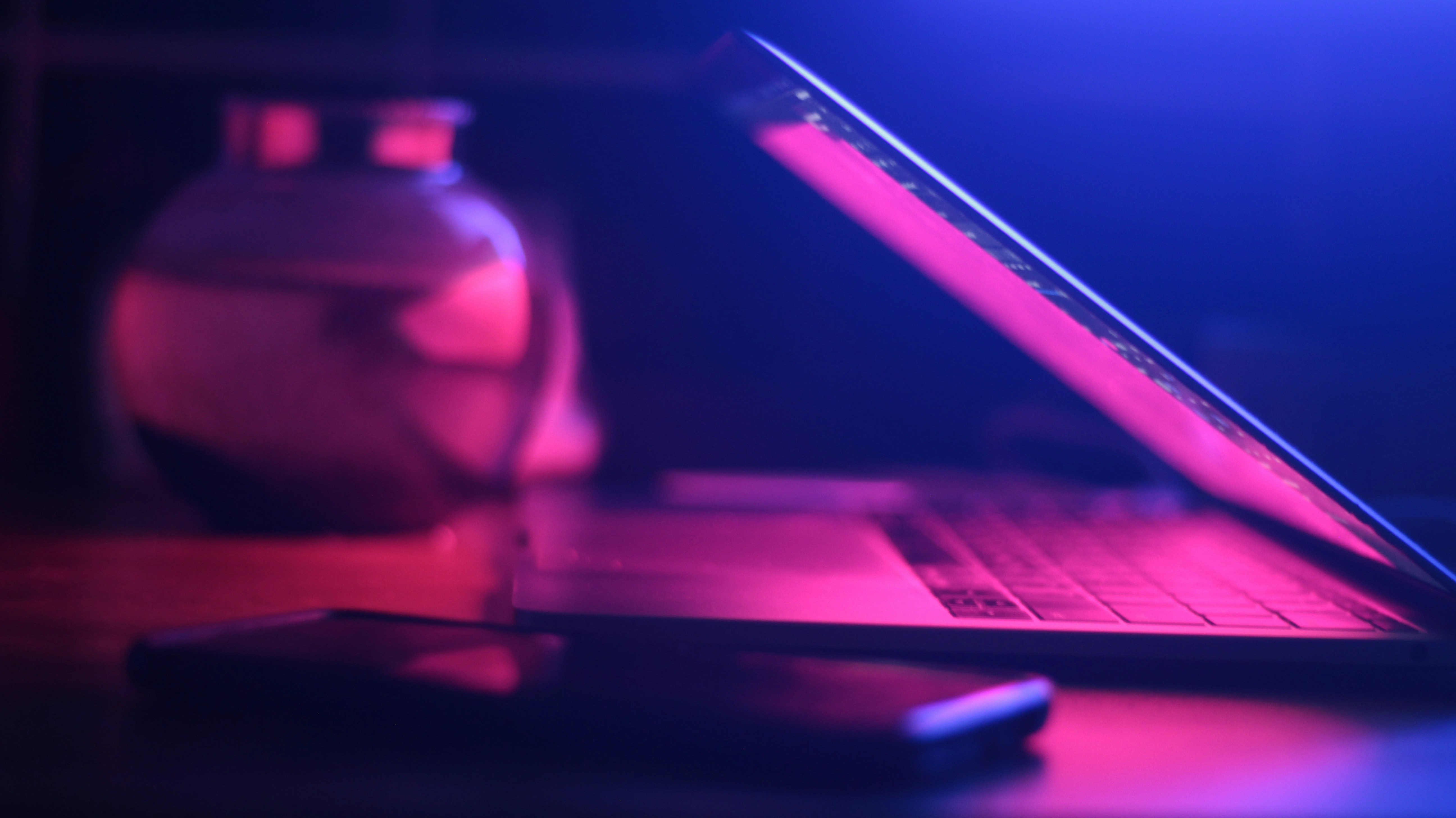 Black laptop computer turned on on table