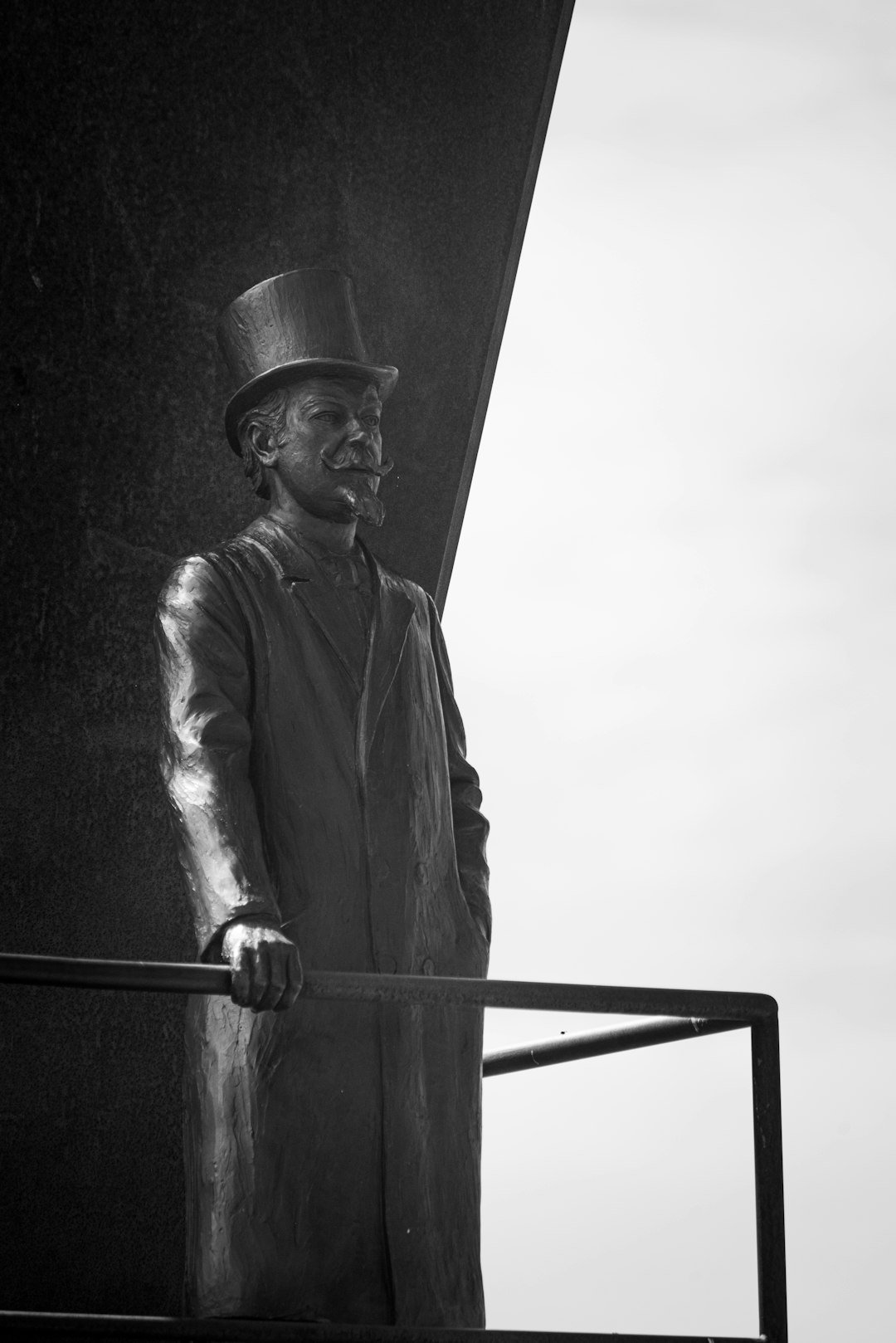 grayscale photo of man holding metal bar