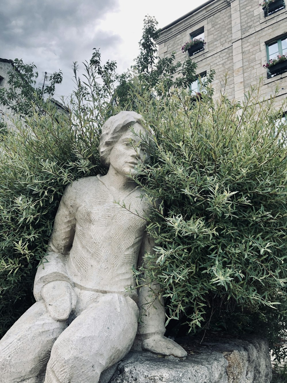 woman statue near green plants during daytime