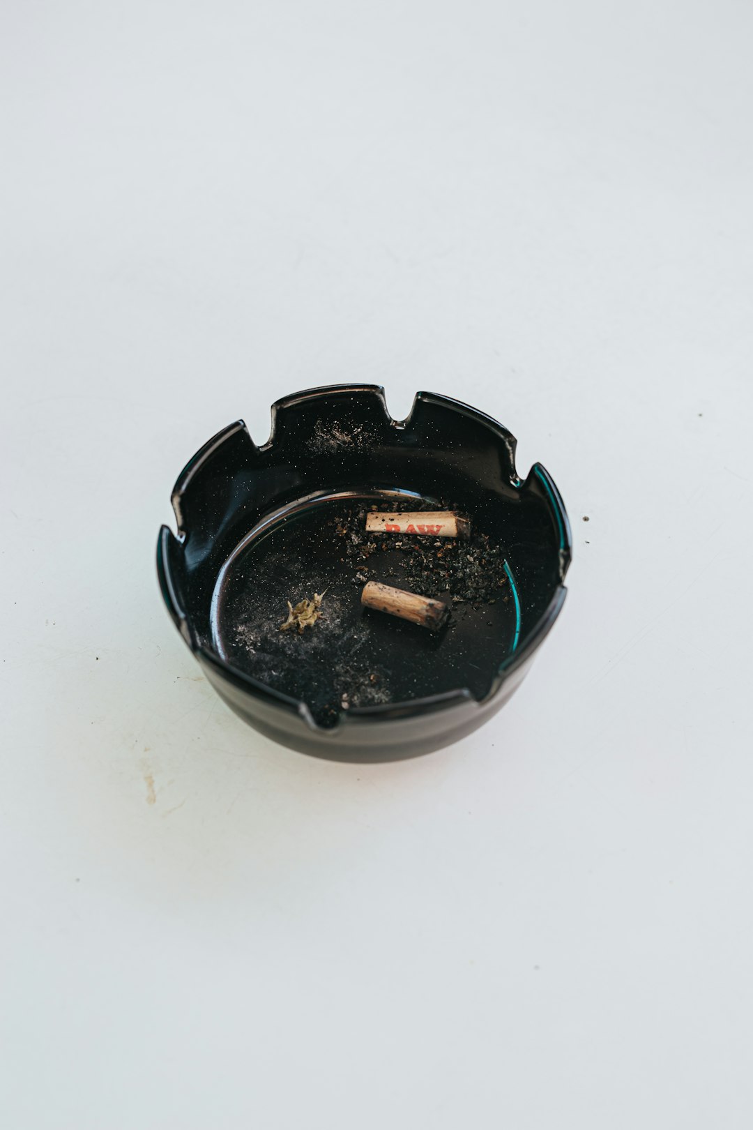 cigarette butts on black round ashtray