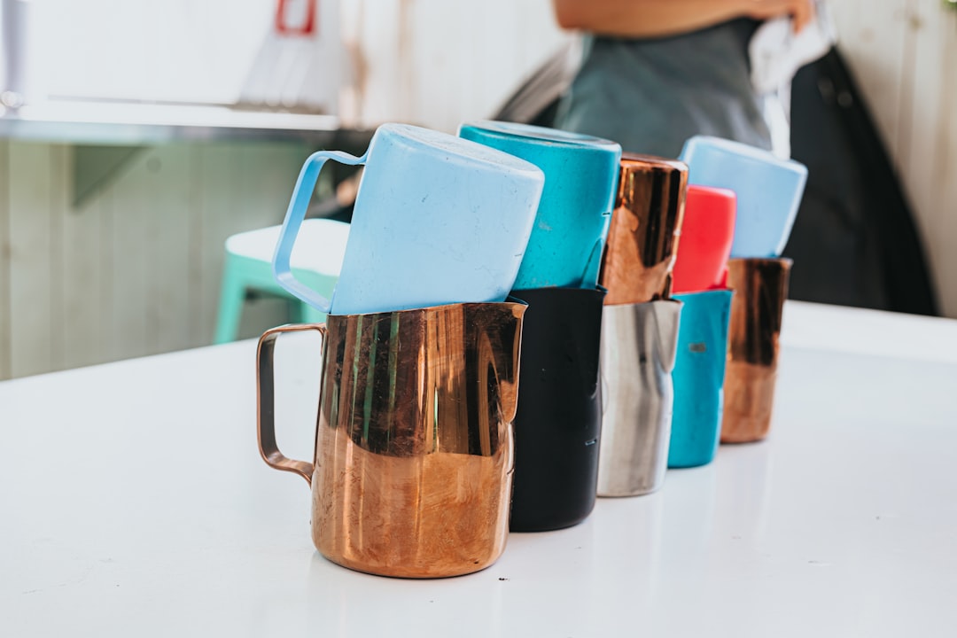 blue and brown ceramic mugs on white table