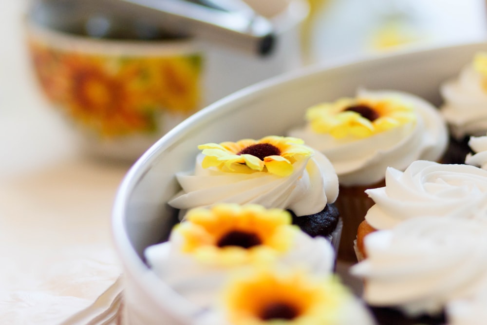 white and yellow cupcakes on white ceramic plate