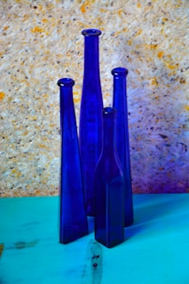Bottles of indigowtr elegantly displayed against a deep indigo backdrop.