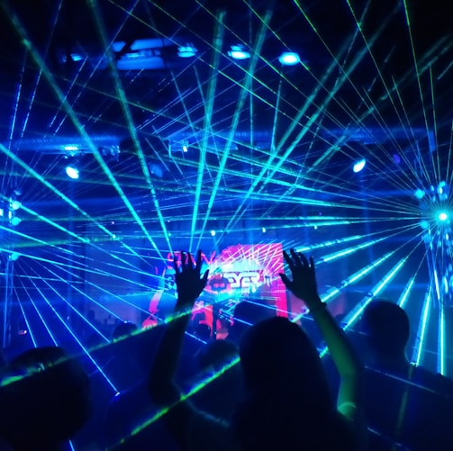 people standing on stage with blue lights