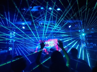 people standing on stage with blue lights