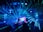 people standing on stage with blue lights
