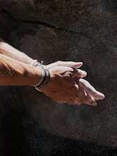 person wearing silver bracelet and white watch