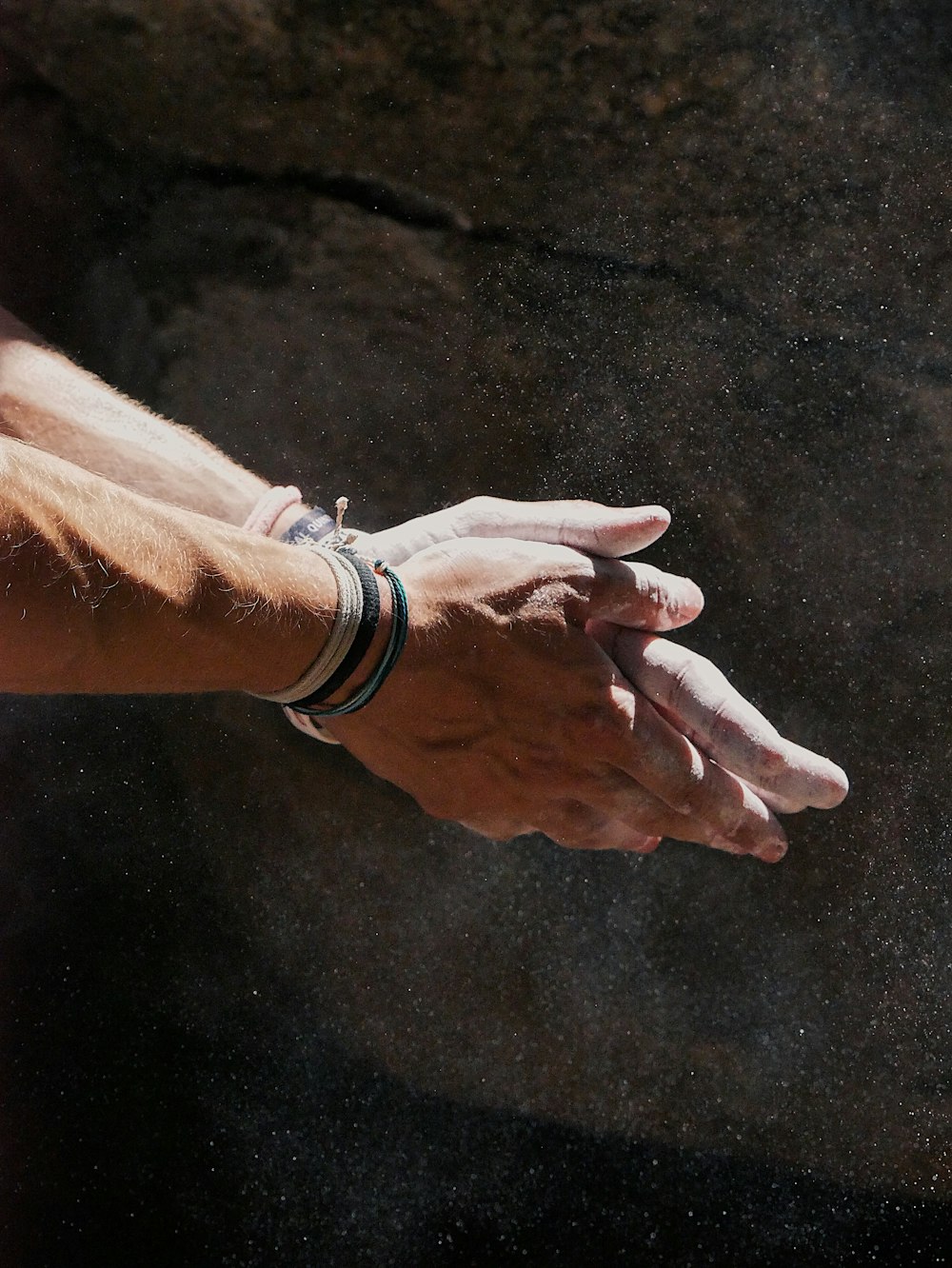 person wearing silver bracelet and white watch