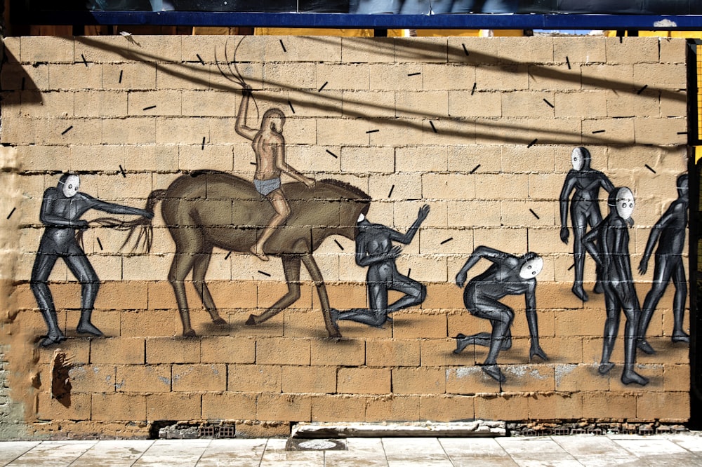 2 men jumping on brown concrete wall