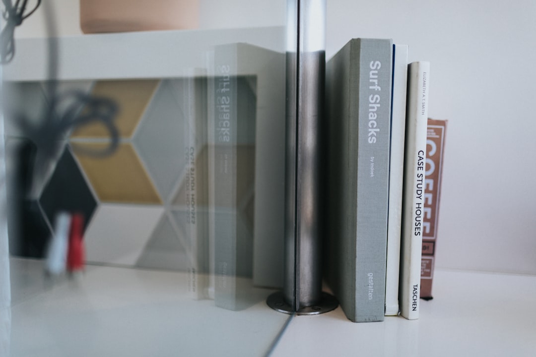 black and red books on white shelf