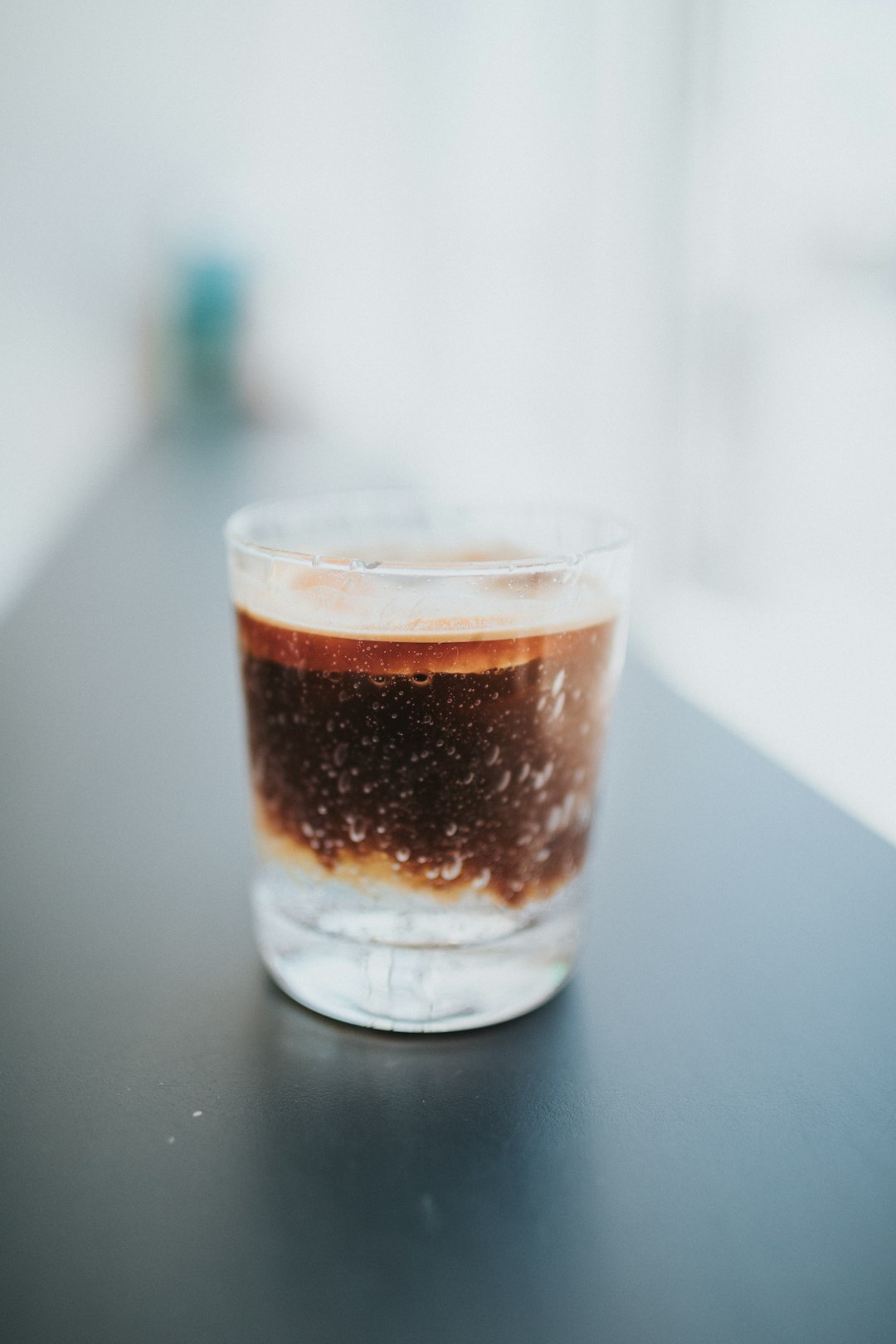 clear drinking glass with brown liquid