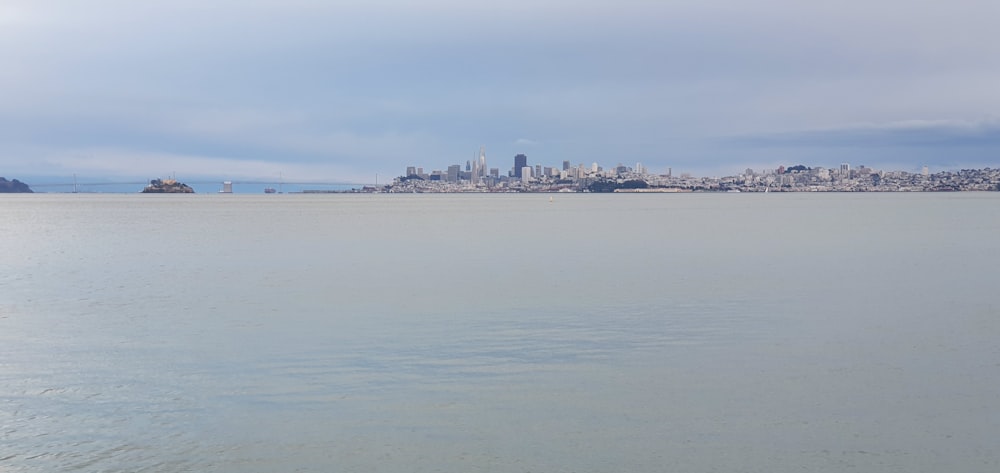 body of water near city buildings during daytime