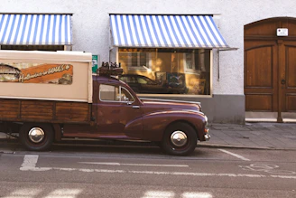 A welcoming storefront of Charley Toppino & Sons with a vintage truck parked outside.