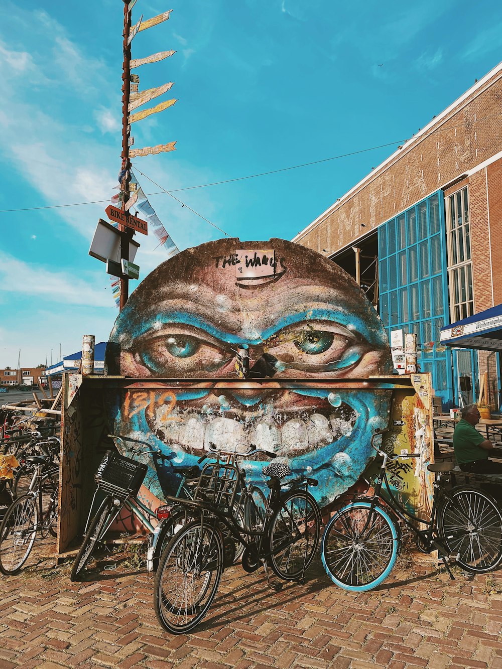 Vélo bleu et noir à côté d’un bâtiment en béton brun pendant la journée