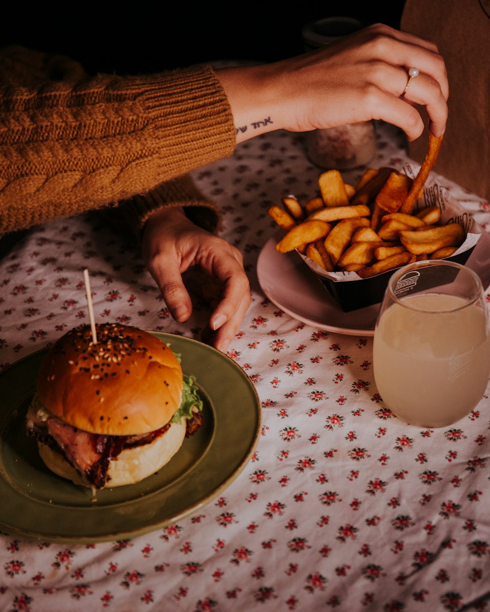 burger with fries on green ceramic plate