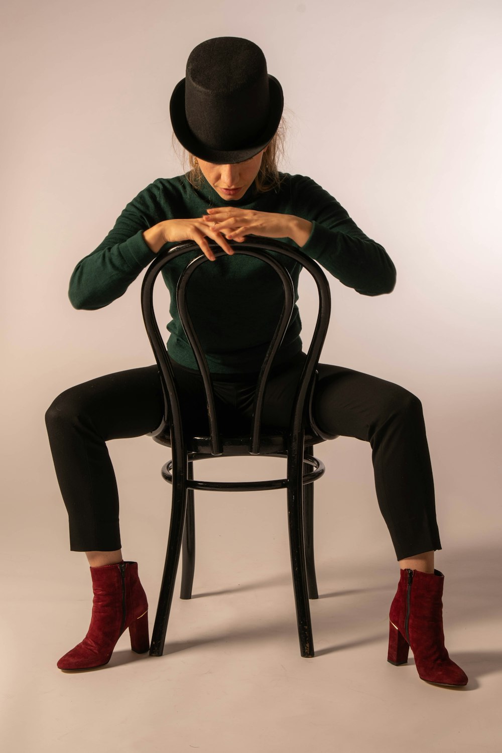 woman in black long sleeve shirt and black pants sitting on black chair