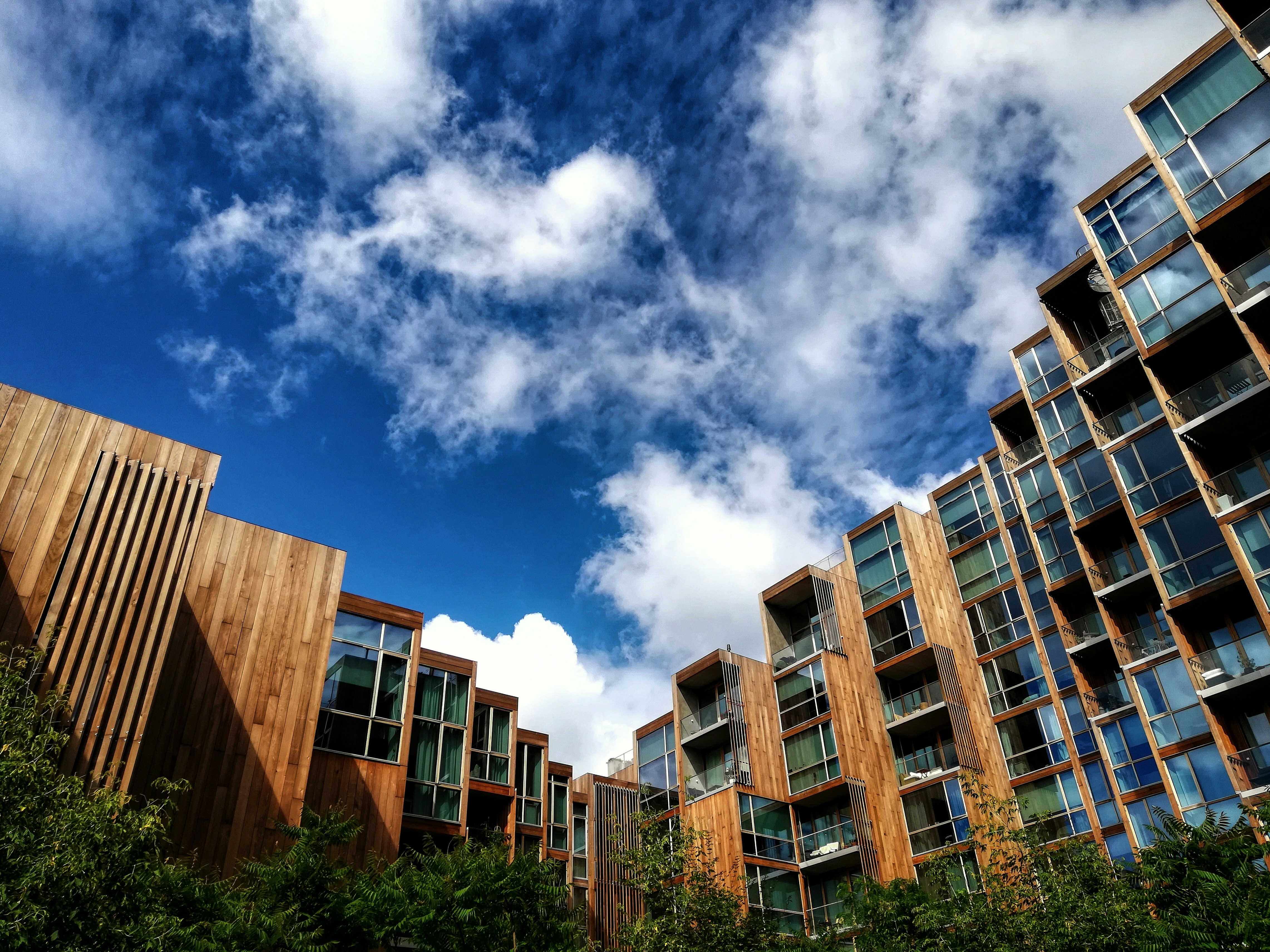 brown and white concrete building under blue sky and white clouds during daytime