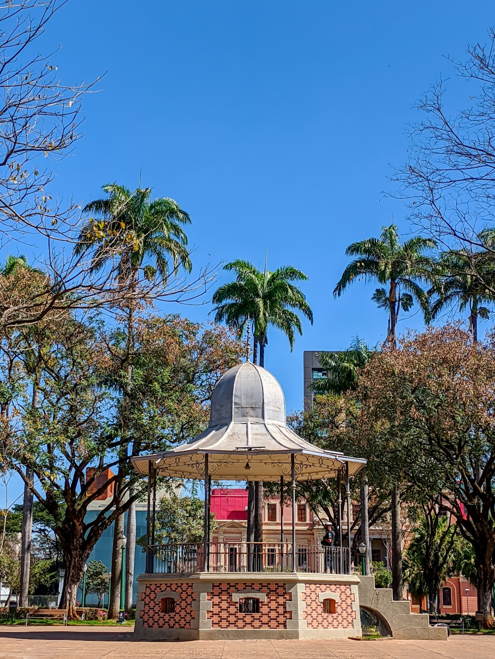 white gazebo surrounded by trees