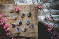 A collection of staurolite fairy crosses displayed on rustic wooden surface with soft natural light.