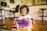 A young artist proudly displaying their colorful painting on a bright easel.