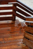 Close-up of sturdy deck railing built with rich wood, highlighting expert craftsmanship.