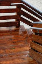 Side-by-side images showing a deck before and after pressure washing, highlighting the wood’s natural color.