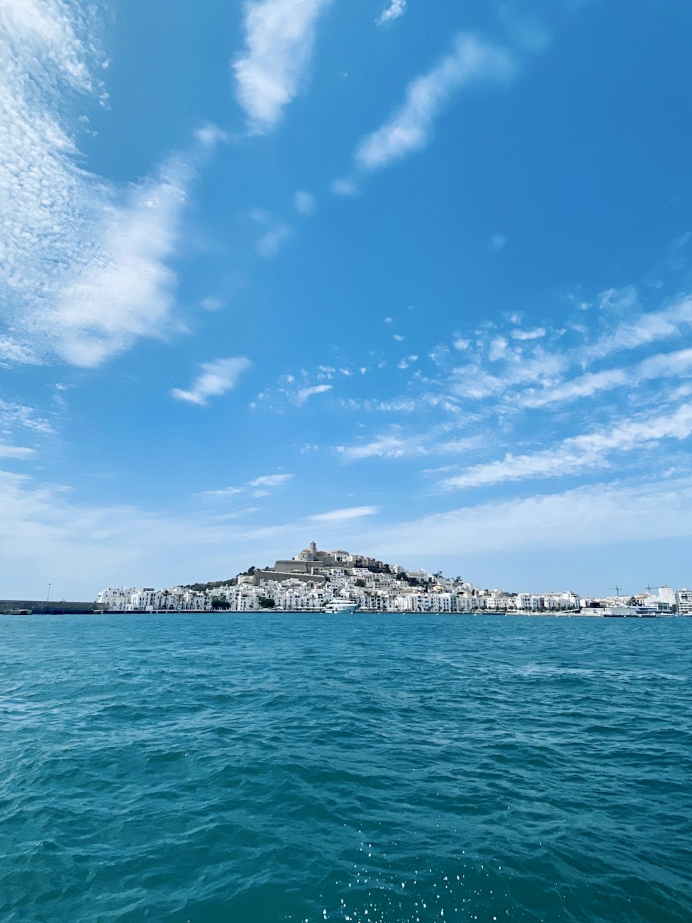 blue sea under blue sky and white clouds during daytime