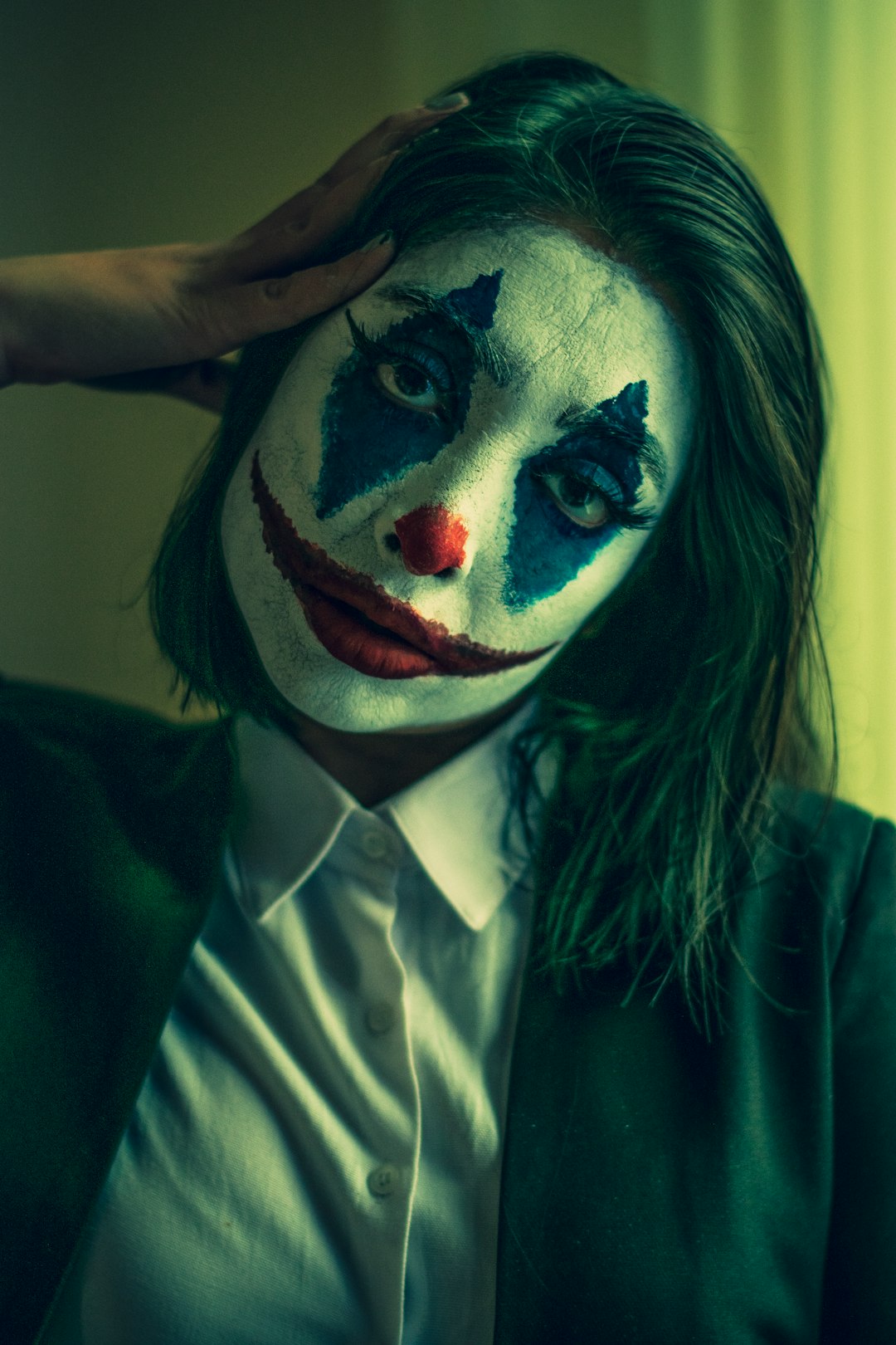 woman in white dress shirt with red and black face paint